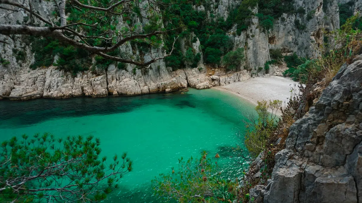 Turquoise water between white limestone cliffs at Calanque d'En Vau