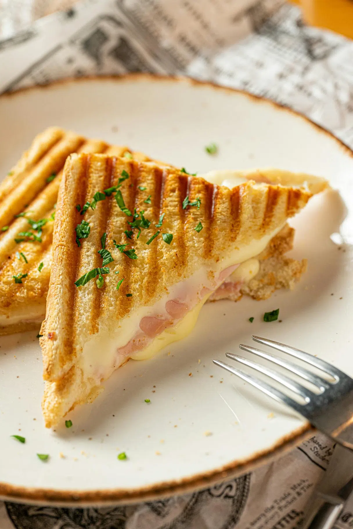 Parisian croque-monsieur: bread, ham, cheese, sometimes béchamel, baked until golden (brasserie classic)