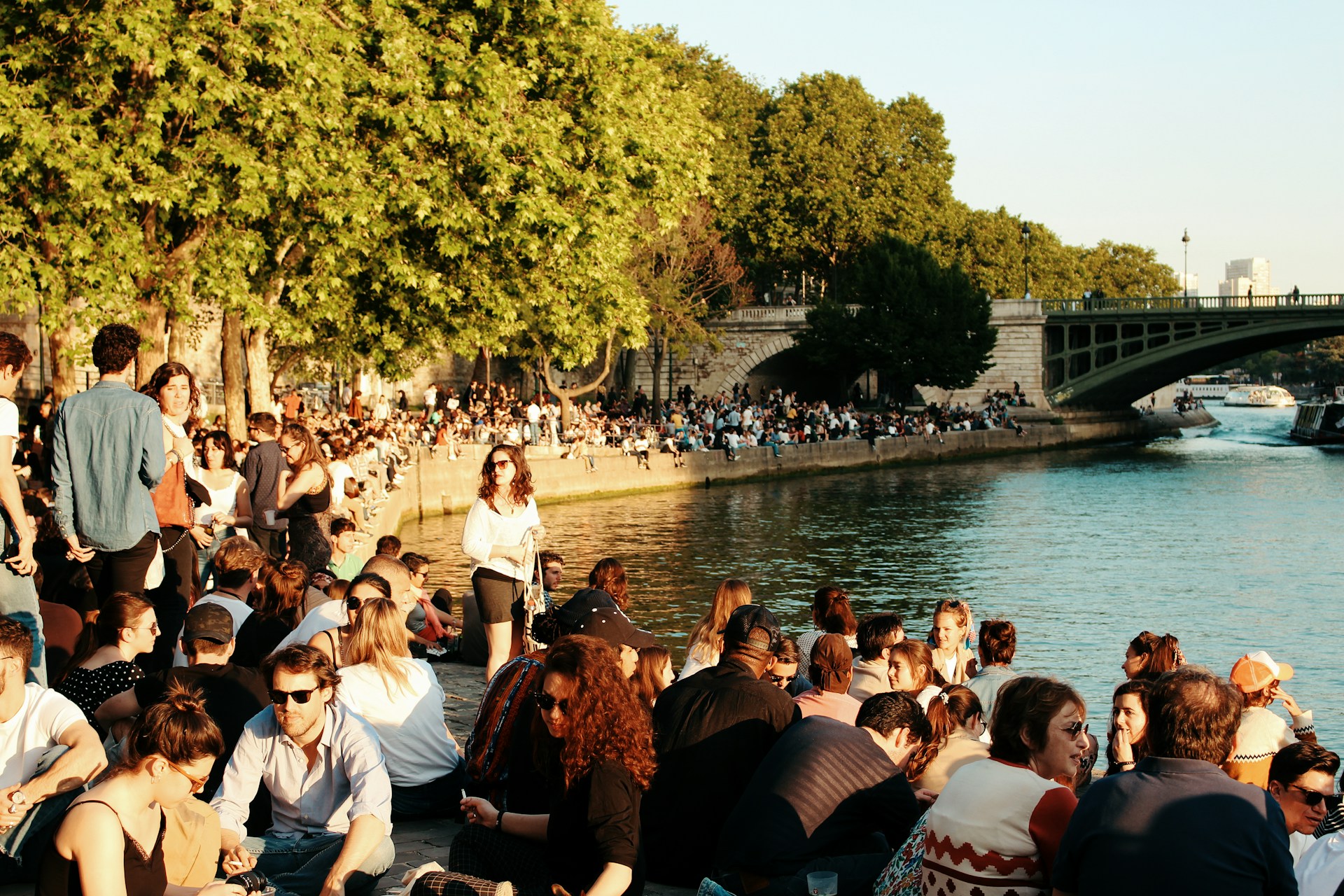 Crowds in Paris near the Eiffel Tower during peak season, illustrating the importance of choosing the right months to visit France