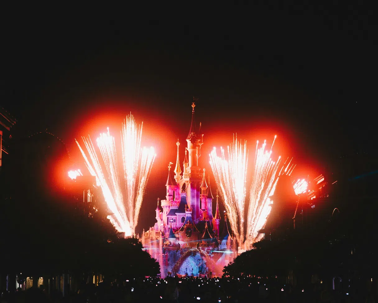 Disneyland Paris castle lit up at night, fairytale atmosphere