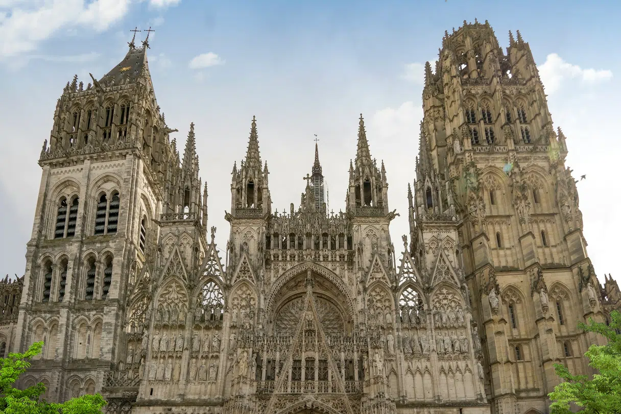 The Gothic facade of Rouen Cathedral rising above the square