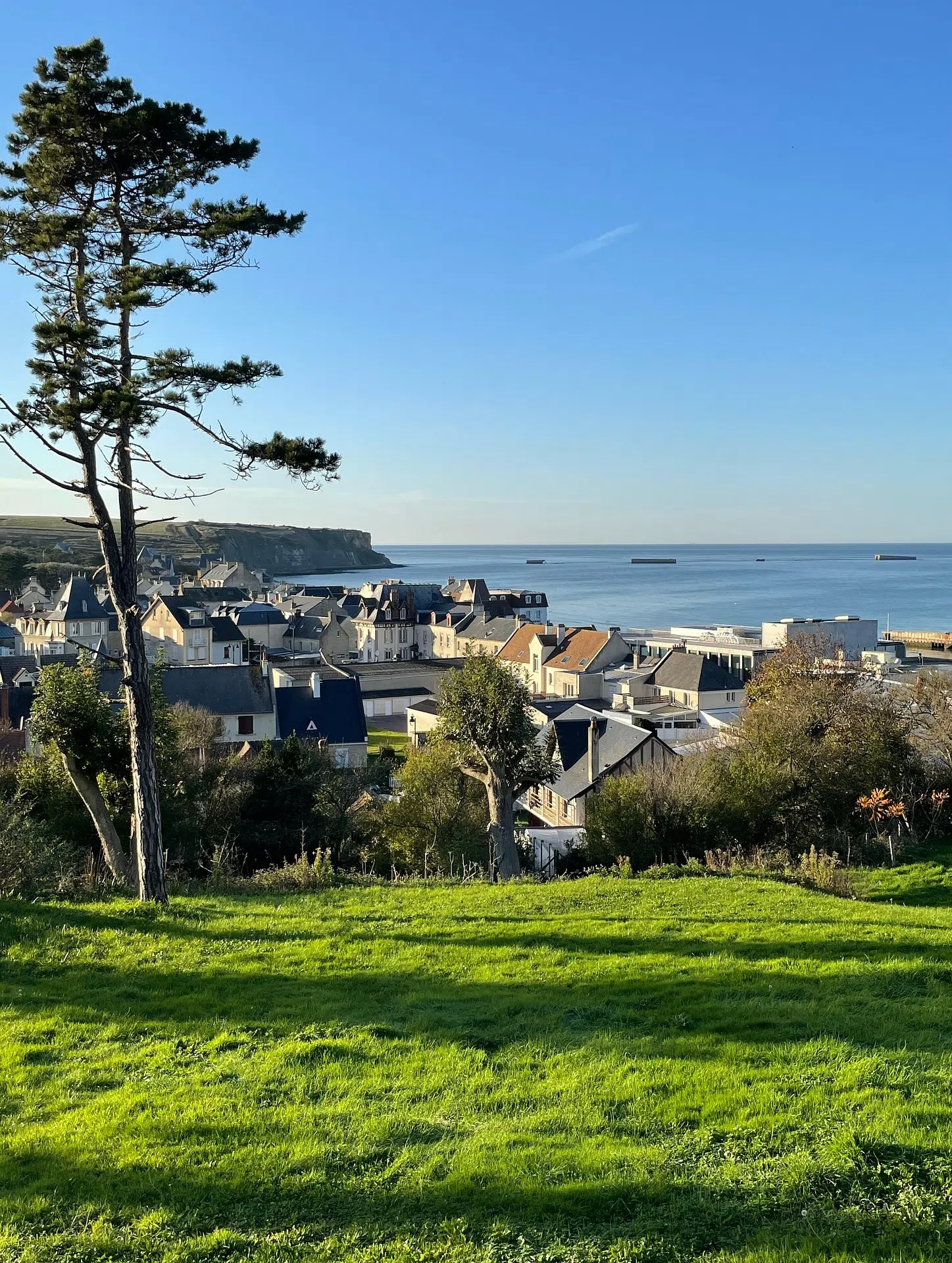The heights of Arromanches with the remains of the artificial harbor in the distance