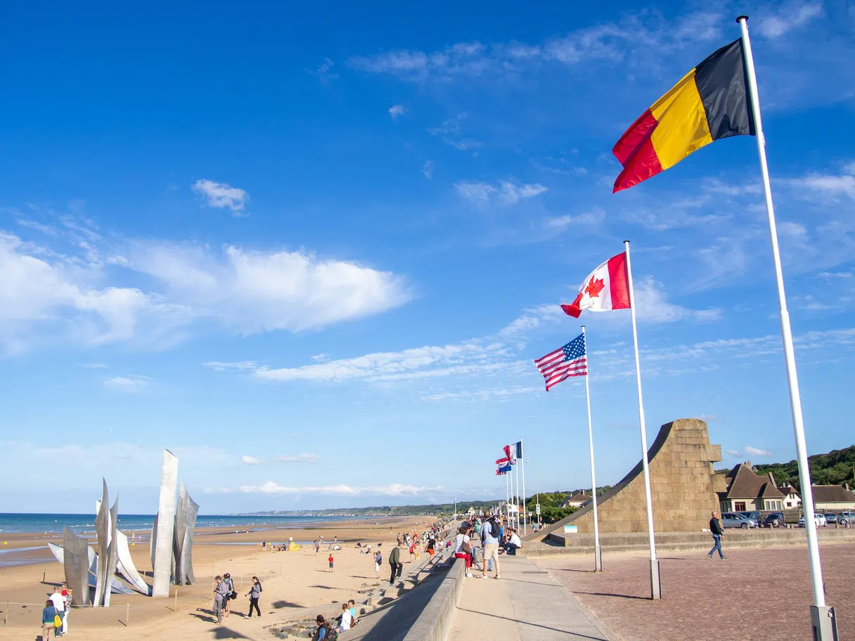 The Les Braves monument and flags on Omaha Beach