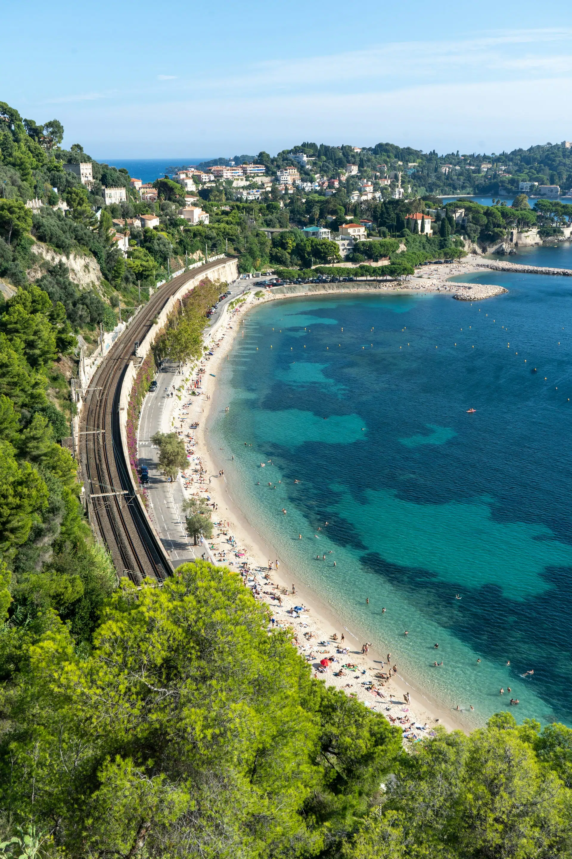 A scenic train traveling through a mountain landscape in the French Alps