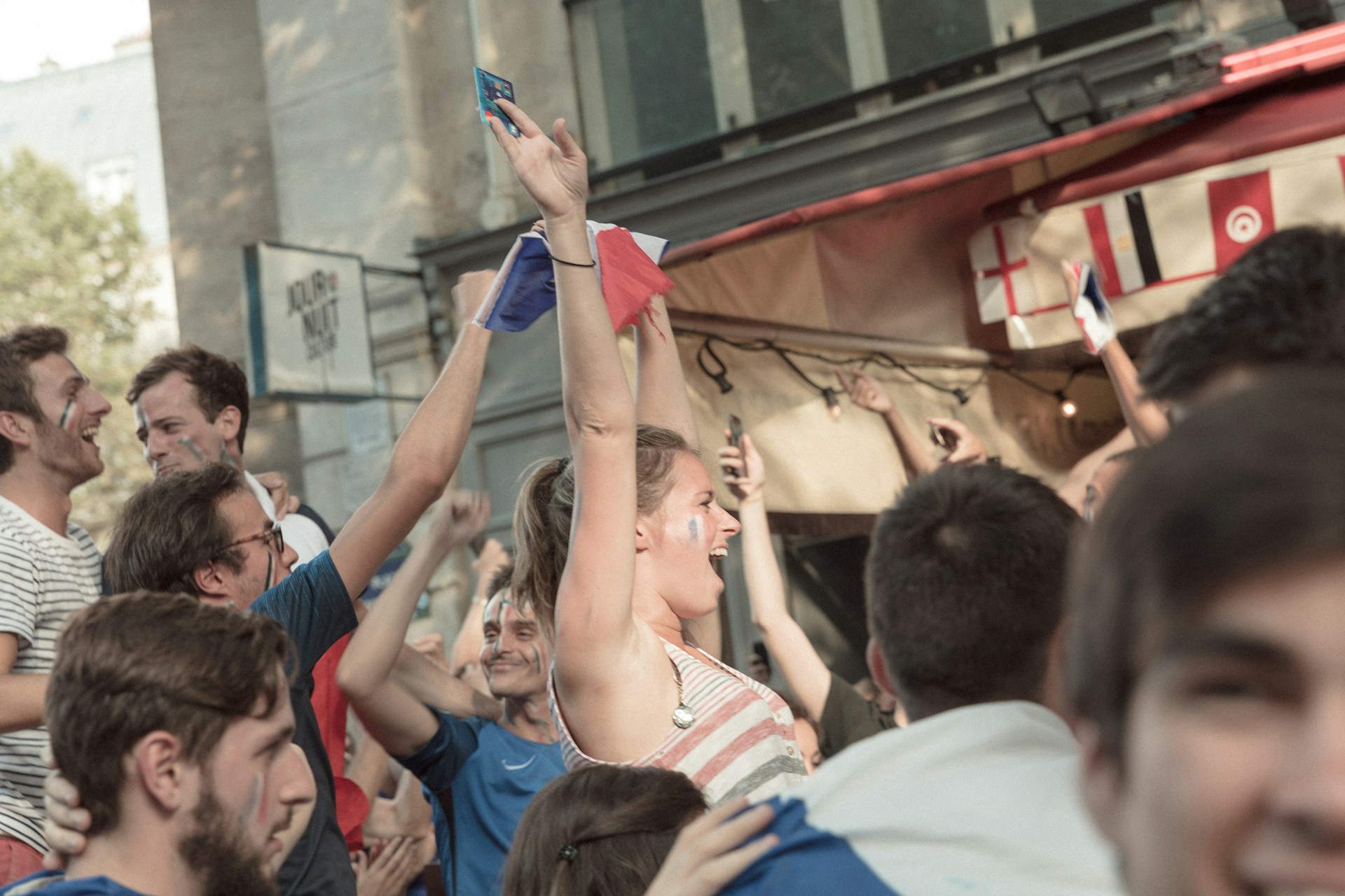 Football fans watching World Cup 2026 in France on a big screen in a lively city bar